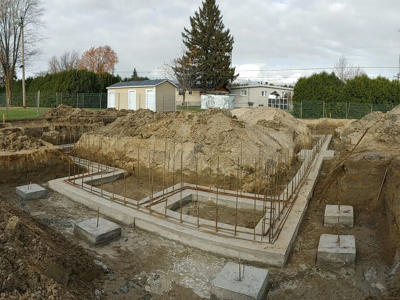 Semelles de fondation en béton coulées dans l’excavation, armatures d’acier en attente