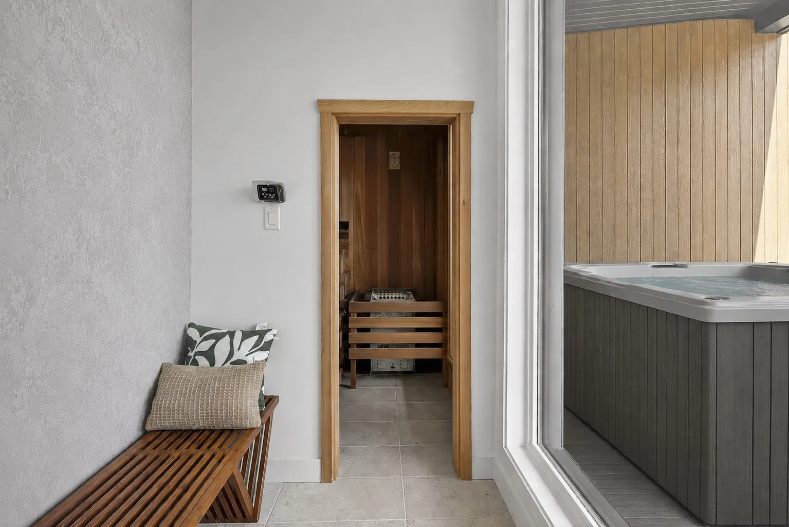 Espace bien-être intérieur avec sauna en bois, spa et banc