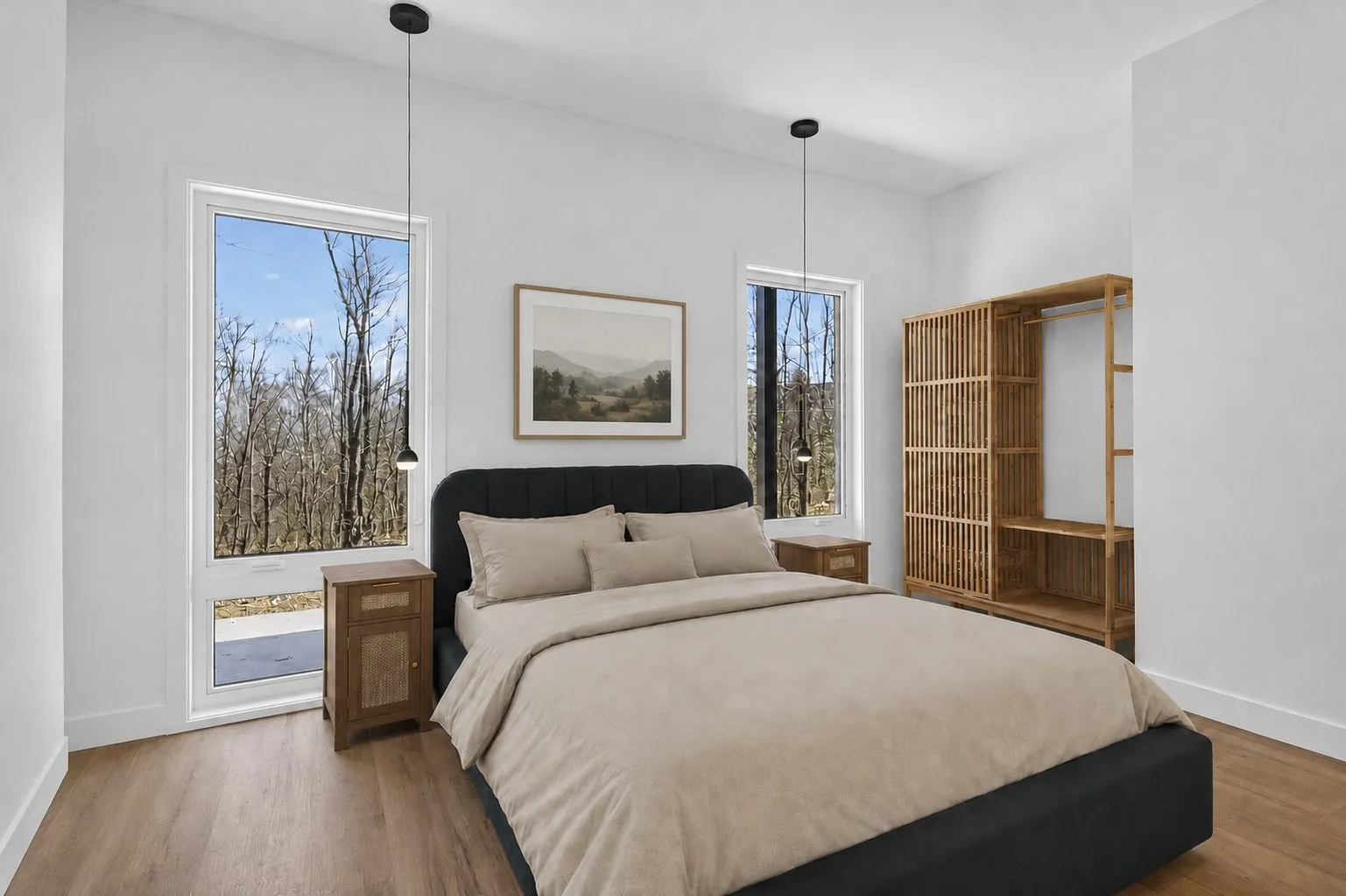 Chambre principale avec lit double, tête de lit en velours anthracite et armoire ouverte en bois